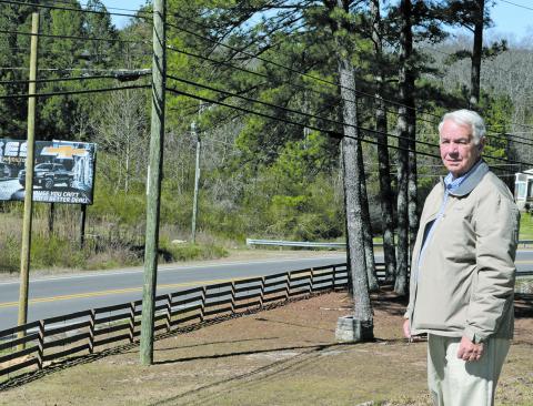 Haleyville Mayor Ken Sunseri at Rocky Ravine Park, showing, at the left in the background, a pole that has been set where fiber optic lines will be run, signaling the coming of high speed internet.