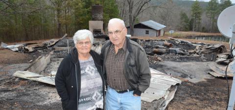 Shirley Griffith and her brother J.C. Farris, stand at the site of a home place full of memories. Their brother Garland Farris safely made it out of the burning home early Saturday, Dec. 7.
