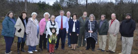 Pictured at the site of the new storm storm shelter in the Ashridge area, from left, community residents and Ladies Auxiliary members Sheila Miller, Geraldine Jetton, Joe Ann Durham, Bonnie Tidwell, Renee Baker, with her grandson, State Representative Tim Wadsworth, Ashridge Assistant Fire Chief Roger Watts, Dr. Nicole Jones, Gene Baccus, Probate Judge Sheila Moore, Commission Chairman Roger Hayes, Commissioner David Cummings, EMA Director A.J. Brown.