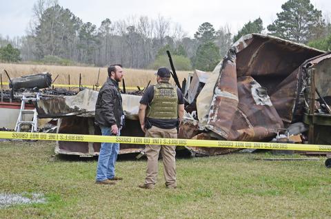 Winston County Sheriff Caleb Snoddy, left, and Chief Deputy Jacob Eward on the mobile home fire scene where two men were found dead.