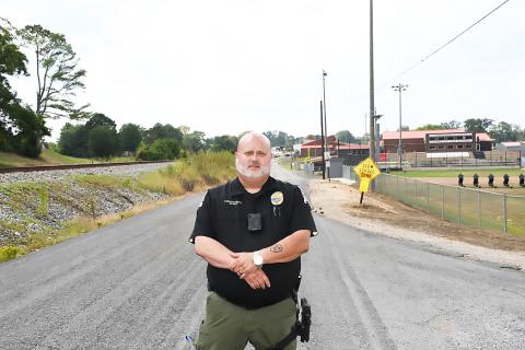 Police Chief Bryan Kirkpatrick standing at the intersection of East Main Street and Vanderford Road, where the former will be blocked during home games this football season.