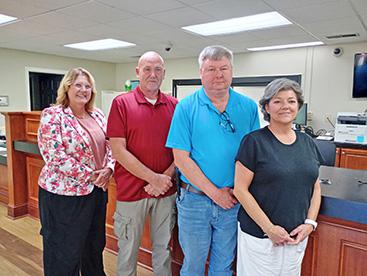 Shown at the Bear Creek Council meeting announcing a new doctor's office for the town, from left, Lakeland Community Hospital President and Chief Executive Officer Cherie Sibley; Mayor Rob Taylor; Dr. Larry Johnston, who will practice at the clinic and his wife, Sherri Johnston, medical clinics manager.