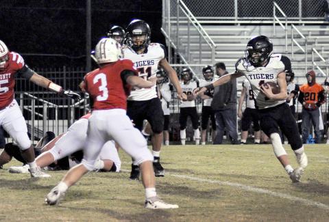 Matthew Clark rushes downfield for Meek.  Also shown is Meek Tiger Angel Chino.
