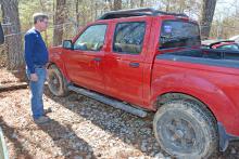 Arley Fire Chief James Rickett inspects the Nissan pickup that was dragged out of the pond late Monday night, Feb. 26.