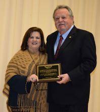 Donna Jones, member of the Haleyville Board of Education, who is past president of the Haleyville Education Association, presents a special award to State Representative Mike Millican for his years of service toward educational issues.