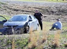 Haleyville Police Officer Nathan Whitman waits with the driver of the Toyota involved in the accident for ALEA to arrive..
