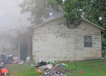 Smoke billows out of the Sam Brewer residence.