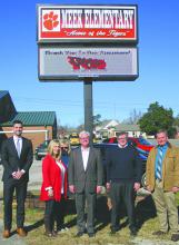 Sponsors and school officials stand in front of the new sign at Meek Elementary School. From left, Jared White, legislative liasion  for Governor Ivey; Heather Tucker, principal; Cyndy Bartlett, math lab facilitator; Greg Reed, senate majority leader; Tim Wadsworth, representative and Allen Owens, manager of Traders and Farmers Bank, Arley. Sponsors not shown are Traditions Bank and Rusty Banks of Lakeshore Properties, Inc.