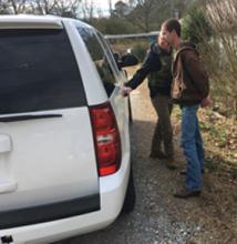 Winston County Sheriff's Office Investigator Caleb Snoddy leads defendant Todd Hood to the patrol car for transport to the Winston County Jail.