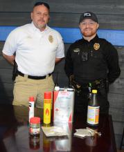 Bear Creek Police Chief Joey Franks, left, and Officer Austin Lewis display drugs and paraphernalia confiscated in their most recent case.