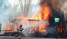 Firefighters brave intense daytime temperatures to fight the second fire at a vacant structure within 24 hours.