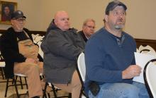 Acting Fire Chief Terrell Baccus, seated front, talks to the council about the need for a fire truck at the council meeting. Also shown are Haleyville firefighters Doug Brakefield, Craig Thomas and David Eckl, sales rep for Emergency Equipment Professionals.