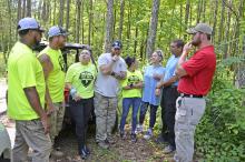 Planning their strategy before Saturday morning's search, from left, Cameron Williams, VET DRTI; Jon Hill, president VET DRTI; Angela Haley Harris, president Aniah's Heart; John Sloan, VP of VET DRTI: Emily Stewart, VET DRTI; Misty Hughes, Shane Hughes, Aniah's Heart. At far right is Winston County Sheriff's Investigator Josh Bennett.