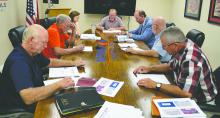 The Winston County Board of Education looks over the budget before approval. From left, Board members Randy Lee, Lamar Frith, Chief Financial Officer Morgan Blankenship, Board President Joey Boteler, Superintendent Greg Pendley and board members Allin Bailey and Mark Finley.