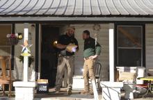 Winston County Sheriff's Investigator Josh Bennett (pictured left) talks with Sheriff Caleb Snoddy while standing on the porch of Martin Grace's residence on 11th Street in Haleyville during the ongoing investigation.