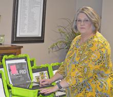 Winston County Election Officer Sheila Moore checks polling pads in preparation for the April 16 runoff election.