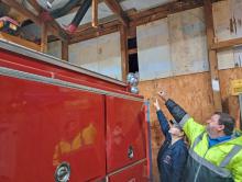 Delmar Fire Chief James Liverett and Lieutenant Zena Ingram show where the fire station roof had been leaking causing flooding issues before a recent grant from the Resource Conservation and Development Council.