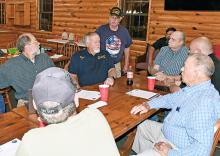 George Gibson, chairman of the Winston County E-9-1-1 Board, standing, addresses concerns at the meeting. Seated around the table from left are Jeff Mobley, attorney representing the E-9-1-1 Board, Interim Director Wayne Collins, dispatcher James Whitman, board member Bryan Kirkpatrick and board member and treasurer Horace Moore. Closest to the camera is Arley Fire Chief James Rickett.