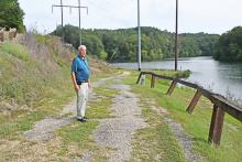 Haleyville Mayor Ken Sunseri shows where the project of widening the trails for Rocky Ravine Park will begin at City Lake.