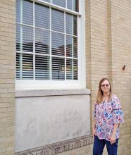Carla Waldep, librarian at the Haleyville Public Library, shows some of the windows to be replaced, thanks to a recent vote of the Haleyville City Council.