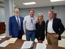 Shown at the signing of papers marking the official approval of the Clear Creek Wilderness Reserve, from left, Commission Attorney Jeff Mobley, Justin Humphries, Lauren Humphries and Hal Isbell, owners of HJL Development LLC, the official company owning the development.