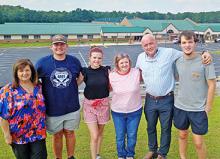 Preparing for the Southern Showdown car and truck show to benefit the family of the late Haleyville City Schools administrator John McCullar, from left, Haleyville Board of Education member Donna Jones; John's children, Will McCullar and Maegan McCullar; John's wife Dr. Jenny McCullar; HCS Superintendent Dr. Bill Bishop and Trey Fox, organizer of the car and truck show.