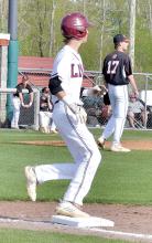 John Whiteside gets to first base on a hit for the Lions. Whiteside drove in four RBIs on three hits.