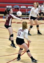 Kaitlyn Burleson takes the serve in action against Fayette. Also shown are Ashton McCullar (3) and Laura Lunsford (11).