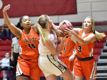 Molly Gilbert takes on three Fayette Lady Tigers in a fight for the rebound Thursday, Dec. 12.